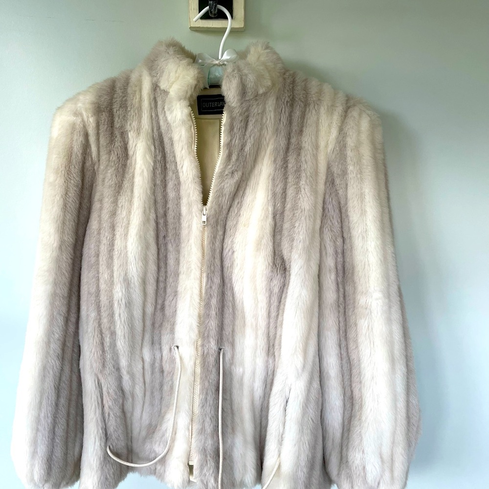 Faux fur coat in shades of white, silver, and gray